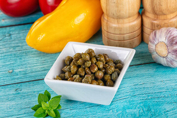 Pickled canned capers in the bowl