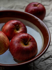 Apples floating in bowl of water