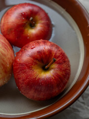 Apples floating in bowl of water