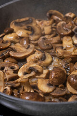 sliced mushrooms and onions sizzling in a hot pan