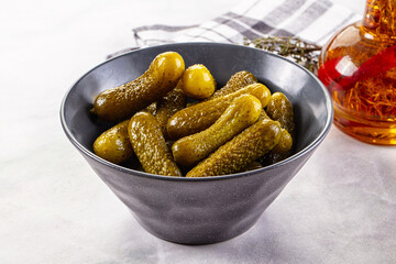 Marinated canned green cornichon cucumbers