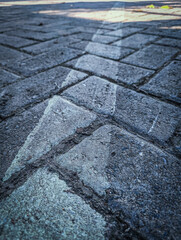 Diagonal white line across rough stone path