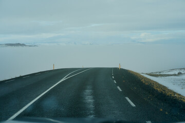 Road trip in Iceland with heavy mist in front of a car , driving travel to collect the northern light of Iceland.