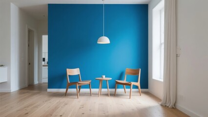 Minimalist living room with blue accent wall, wooden chairs, and pendant light