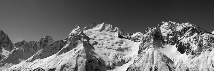 Black and white panorama of snow mountains.