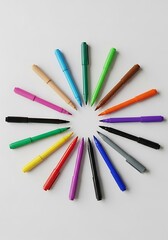 Vibrant circle arrangement of colorful marker pens on a white background