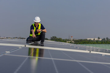 Engineer service check installation solar cell on the roof of factory. Engineers walking on roof inspect and check solar cell panel. Engineer working inspection installation solar cell on the roof