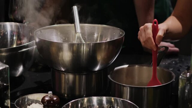 A group of people in a cooking class studio. Demonstration of culinary techniques. Professional kitchen accessories for the restaurant. Cooking on the stove.