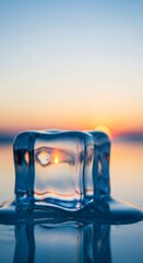 Ice cube refracts sunset over ocean