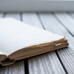 Open sketchbook with blank pages rests on a wooden surface.