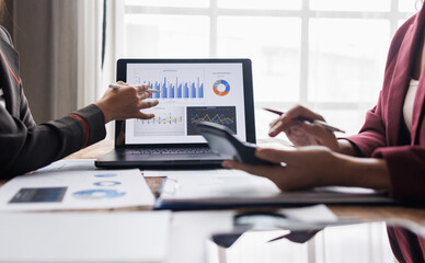 Business team using calculator for analysis maketing plan, Accountant calculate financial report, computer with graph chart. Business, Finance and Accounting concept
