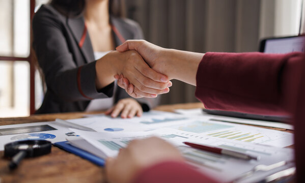 business making handshake with partner, greeting, dealing, merger and acquisition. Hands of senior and young businessmen shaking after agreement on meeting
