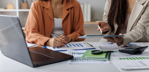 Team of business or accountant hand holding pen working on calculator to calculate business data, accountancy document and laptop computer at office, business concept