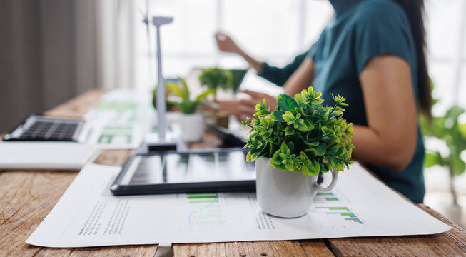 ESG data presentation with professionals analyzing digital trends
Engineers analyzing charts and discussing eco-friendly building project for sustainable development
