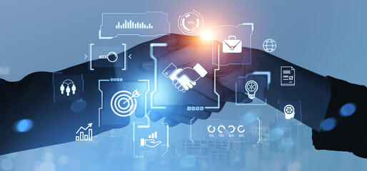 Business handshake with digital interface icons on blue background symbolizing success.