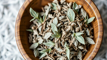 Dried sage herb in a wooden bowl