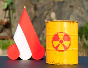 Small flag and radioactive barrel on dark surface