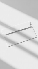 Clean white envelope casting subtle shadow on minimalist background with soft light