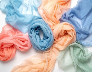 Pastel-colored sheer scarves arranged artfully on a white background, showcasing their delicate texture and soft hues