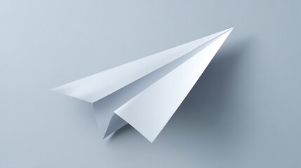 Folded white paper airplane on light gray surface
