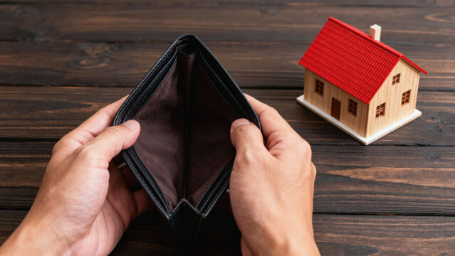 Rising housing cost creates financial stress as empty wallet shows economic hardship