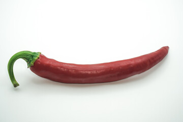 Vibrant red chili pepper, a symbol of heat and flavor, elegantly displayed on a clean white background, highlighting its smooth texture and fresh green stem, perfect for culinary and spicy food themes