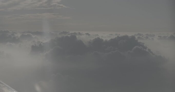 Vibrant clouds and sunlight views from an airplane wing