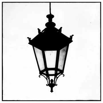 Vintage lantern silhouette with an ornate design on a stark white background