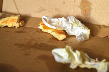 Pizza box with leftover meal. Used cardboard pizza box with greasy food remains.