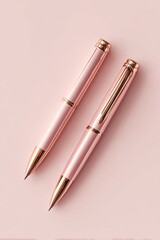 Two pink pens on a pink background