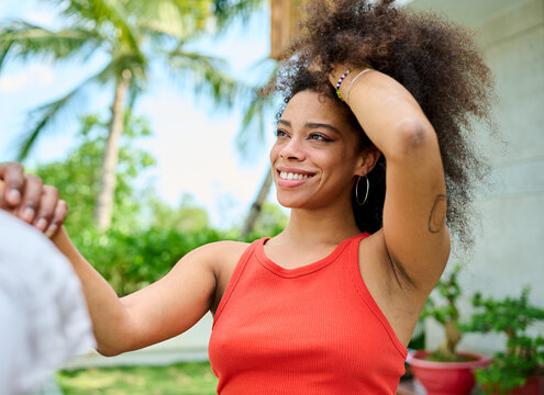 Young couple walking, bonding and enjoying a summer party by a pool, vacation love and bonding concept, luxury villa real estate