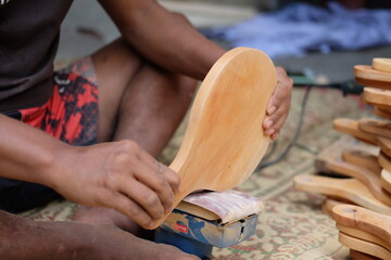 close up of hands of the carpenter. sanding machine. wood.