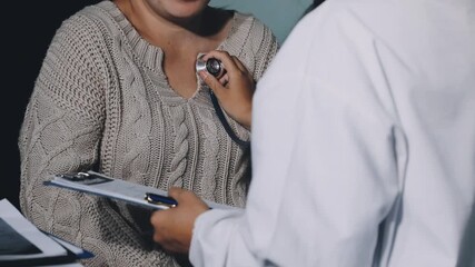 Young doctor is using a stethoscope listen to the heartbeat of the patient. Shot of a female doctor giving a male patient a check up