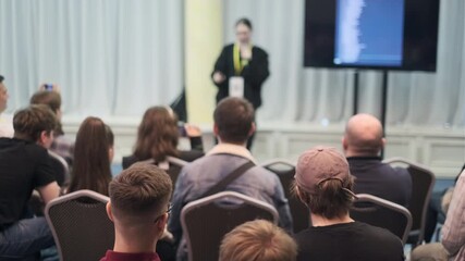 Group of people attending a presentation focused on education and learning in a conference setting. - Powered by Adobe