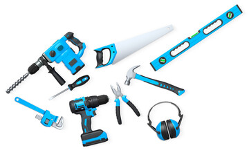 Assorted construction tools including drill, saw, pliers, and headphones on white background with clipping path, concept of DIY