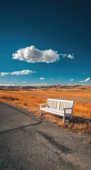 Empty white bench by a country road under a vibrant sky
