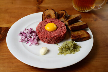 Beef Tartare Hovezi Tatarak Czech Style with Raw Egg Yolk, Topinki Toasted Bread Red Onion and Gherkin