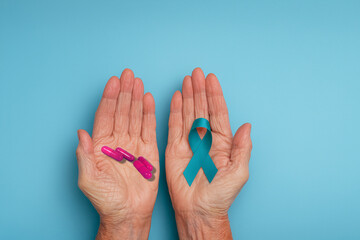 Pair of elderly hands holding awareness ribbon and medicine, representing healthcare, mental health, resilience, and treatment awareness.