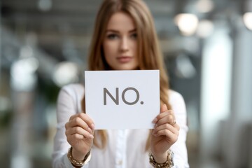 A Determined Individual Holds a Sign with the Word 'NO' Displayed Prominently, Expressing Strong Rejection or Disagreement in a Professional Setting