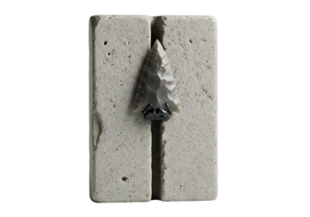A closeup of a prehistoric arrowhead embedded in a stone block, isolated on transparent background, revealing the craftsmanship of ancient toolmaking
