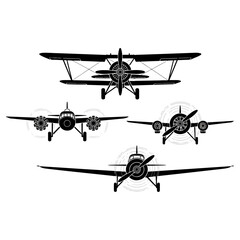 Four different airplane silhouettes in front view, black and white. © tere