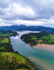 Fototapeta premium Aerial view of a river valley with mountains