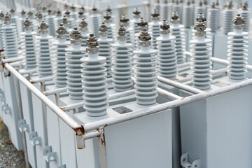 Close up view of capacitor bank units with ceramic insulators in electrical substation, essential...