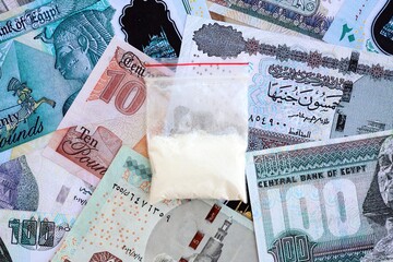 Egyptian pound currency money bills and cocaine pack. The concept of drug trafficking
