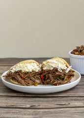 Delicious Venezuelan arepa stuffed with shredded beef and cheese, a traditional Latin American street food dish