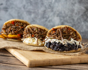 Delicious Venezuelan arepa stuffed with shredded beef and cheese, a traditional Latin American street food dish