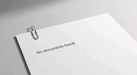 Plain White Paper Sheet with Paperclip and 'No documents found' Text, Symbolizing Empty Search Results or Missing Information