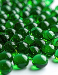 Close-up of numerous glossy, dark-green spherical capsules arranged in rows on a white background, reflecting light