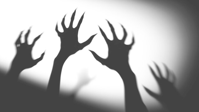 silhouette of hands with light,Shadow overlay effect for halloween background with Terrifying scary hands with long nails,Creepy monster claw,zombie hand rising out of a graveyard
