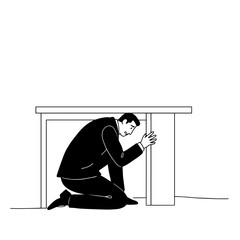 Man crouching under table in suit showing stress and anxiety  